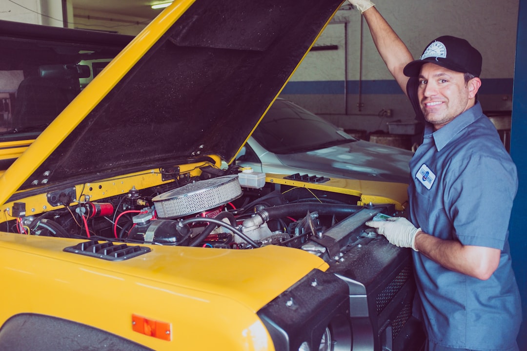 Man holding open-wide car trunk